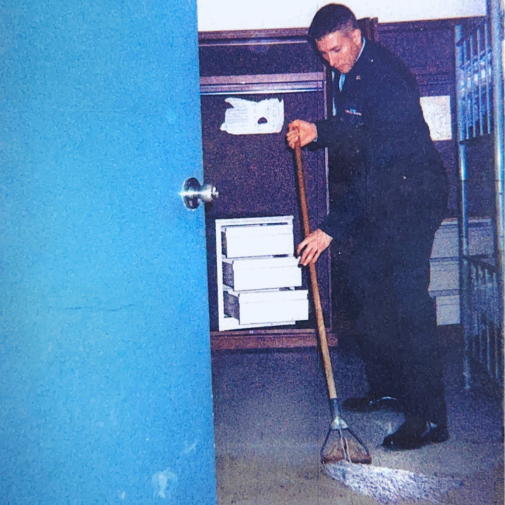 Cody Mattern mopping the floor in military dress