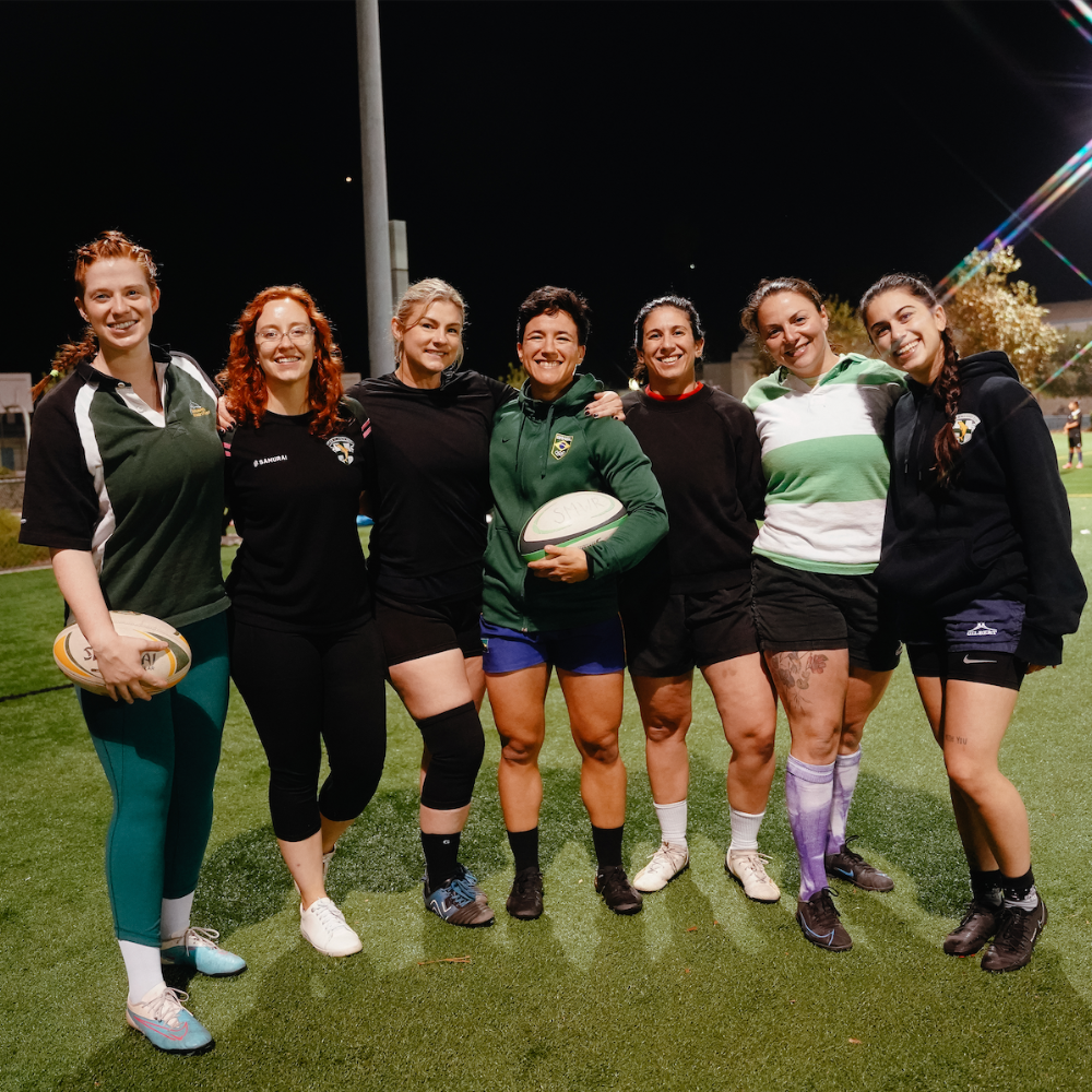 Izzy standing with a group of teammates from the Santa Monica Women's Rugby team