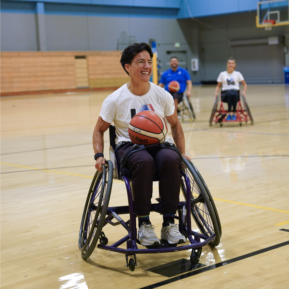 Izzy playing wheelchair basketball