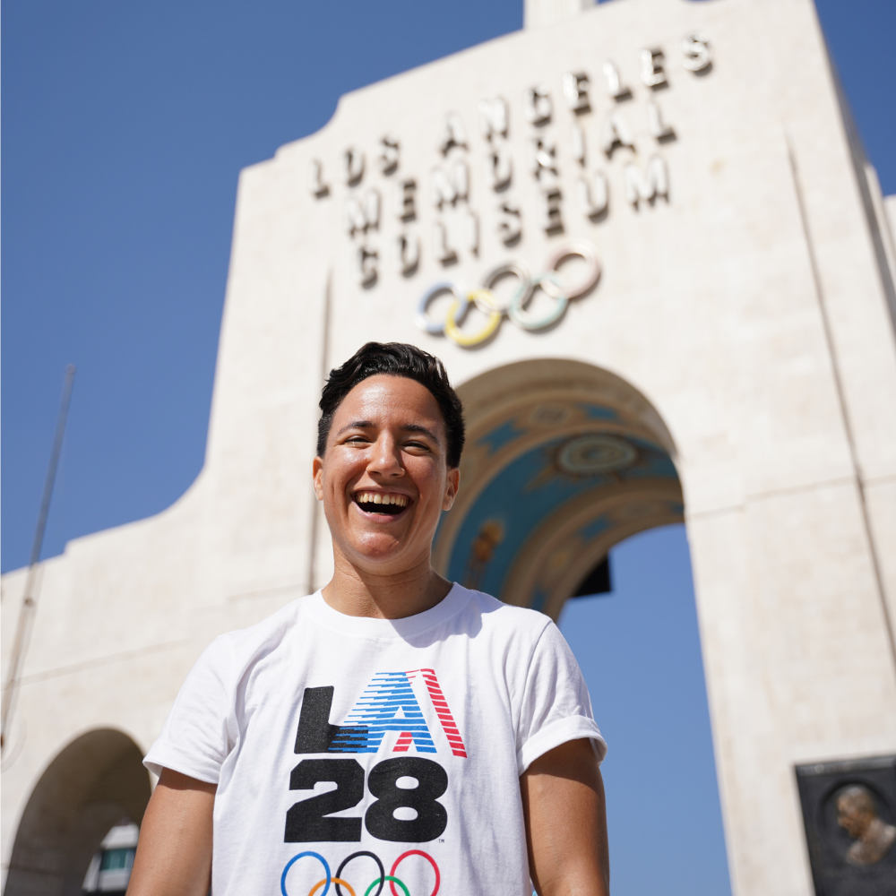 Izzy smiling in front of the LA Memorial Coliseum