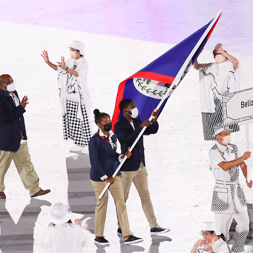 Sam Dirks walking in the Tokyo 2020 Opening Ceremonies holding the Belizean flag